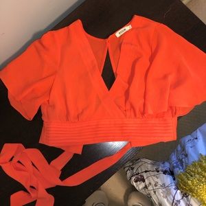 Orange backless tie back cropped blouse.